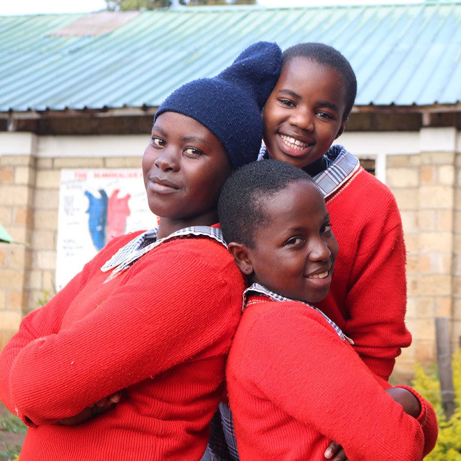 Three older students smiling