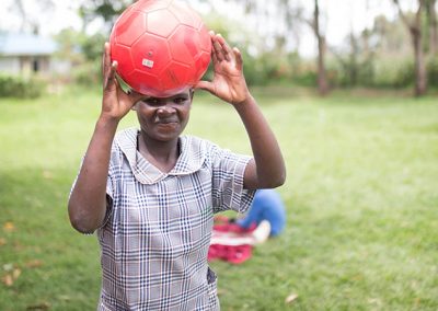 OLOG Student playing with a ball